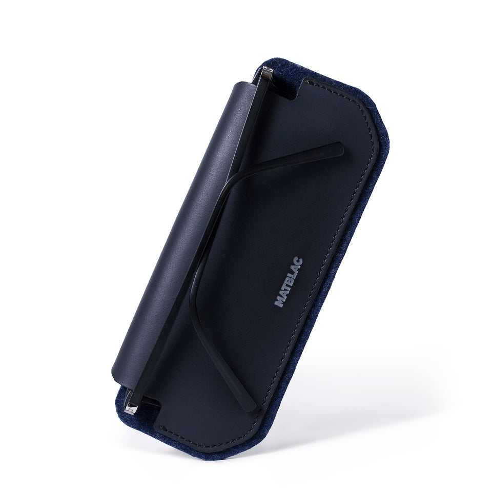 Black leather and felt sunglass case on white background