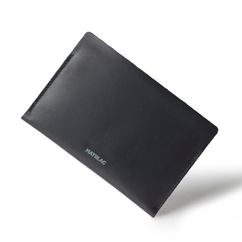 Black genuine leather passbook on white background