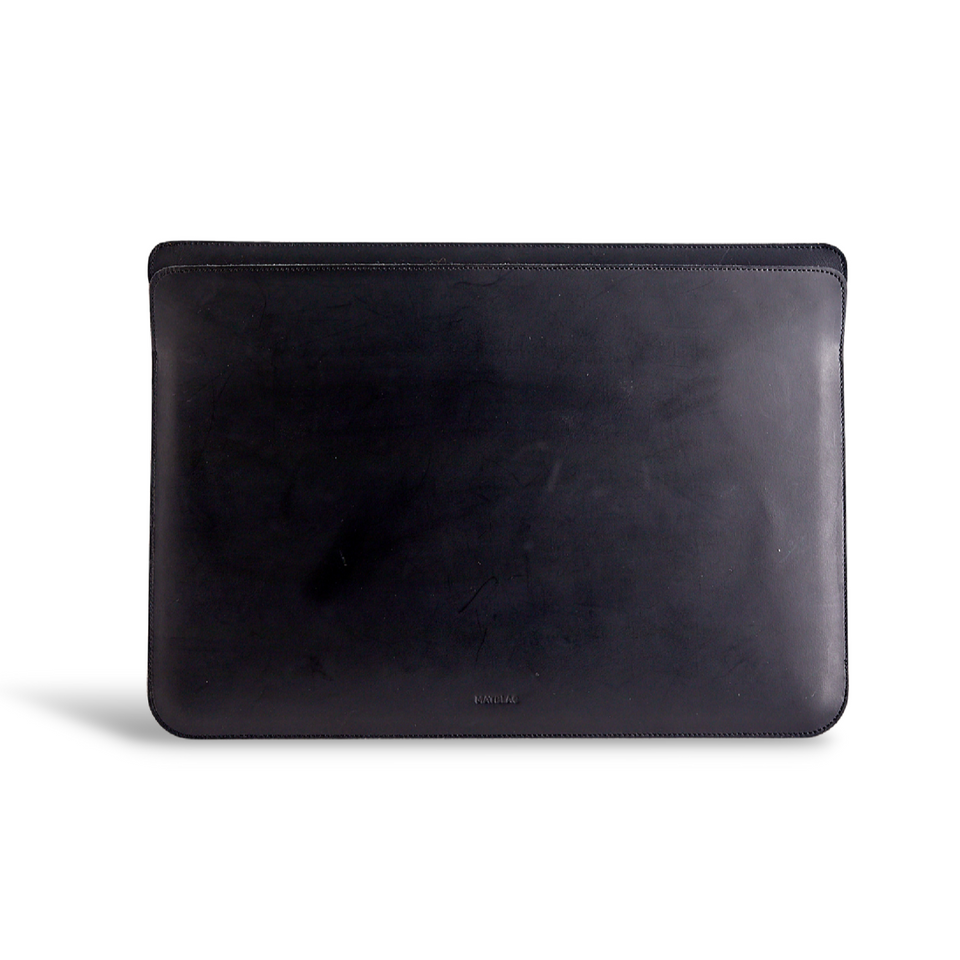Close up of minimalist black genuine leather laptop bag on white background